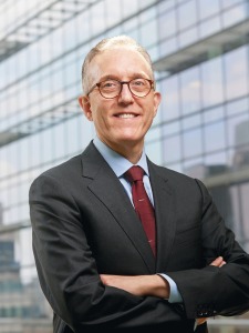 Portrait of middle-aged white man, Dr. Jedd Wolchok, wearing glasses, powder blue collared shirt, dark grey blazer and maroon tie.