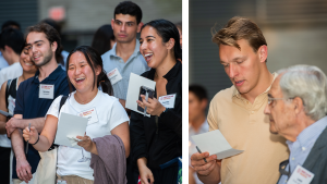 Medical students laughing; a young man and an older man stand next to each other.