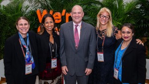 Four women and a man pose for a photo.
