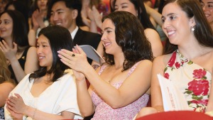 Seated students clapping during the ceremony.