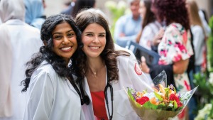 Two women in the Weill Cornell Medicine Class of 2027 celebrating at their White Coat Ceremony